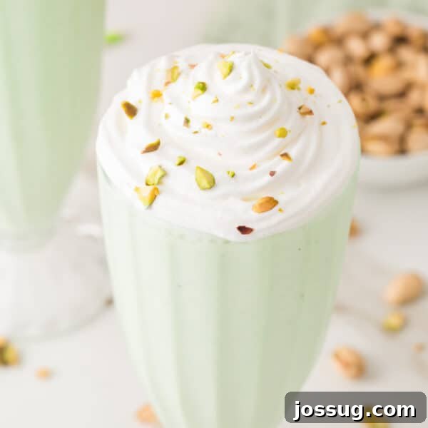 Pistachio Cheesecake with White Chocolate-Pistachio Ganache 16 Pistachio milkshake topped with whipped cream and chopped pistachios in a square food photo