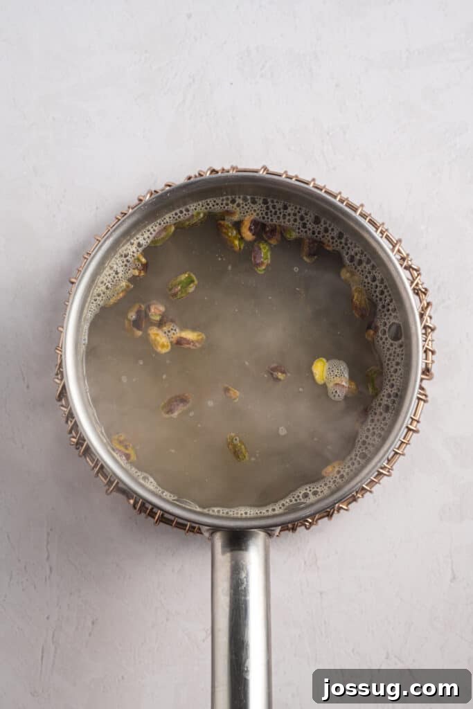 Pistachio Cheesecake with White Chocolate-Pistachio Ganache 5 Pistachios blanching in hot water to remove the skins