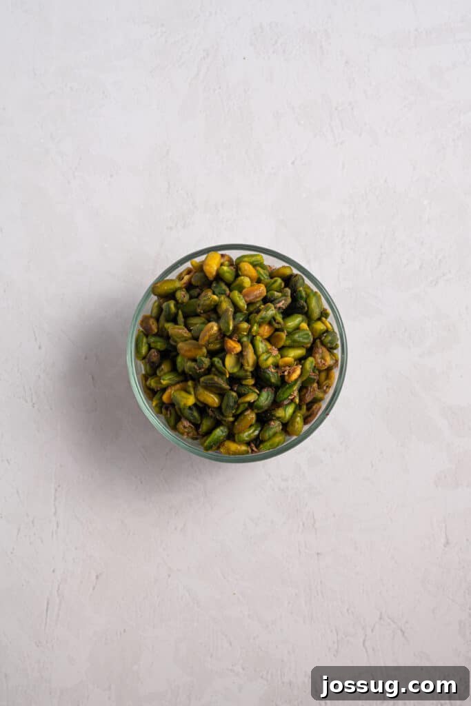 Pistachio Cheesecake with White Chocolate-Pistachio Ganache 7 Peeled green pistachios in a glass bowl for homemade pistachio paste