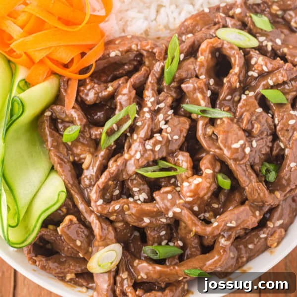 Slow Cooker Asian Pot Roast with Ginger Soy Glaze 11 Square image of Korean Beef Bulgogi served with white rice, cucumber ribbons, carrots, sesame seeds, and green onions