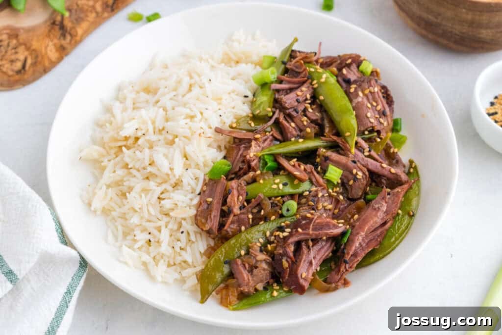 Slow Cooker Asian Pot Roast with Ginger Soy Glaze 4 Asian pot roast served with white rice, snap peas, green onions, and sesame seeds