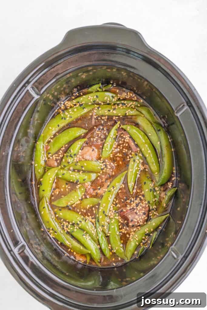 Slow Cooker Asian Pot Roast with Ginger Soy Glaze 8 Slow Cooker Asian Pot Roast with snap peas and sesame seeds in the thickened savory sauce