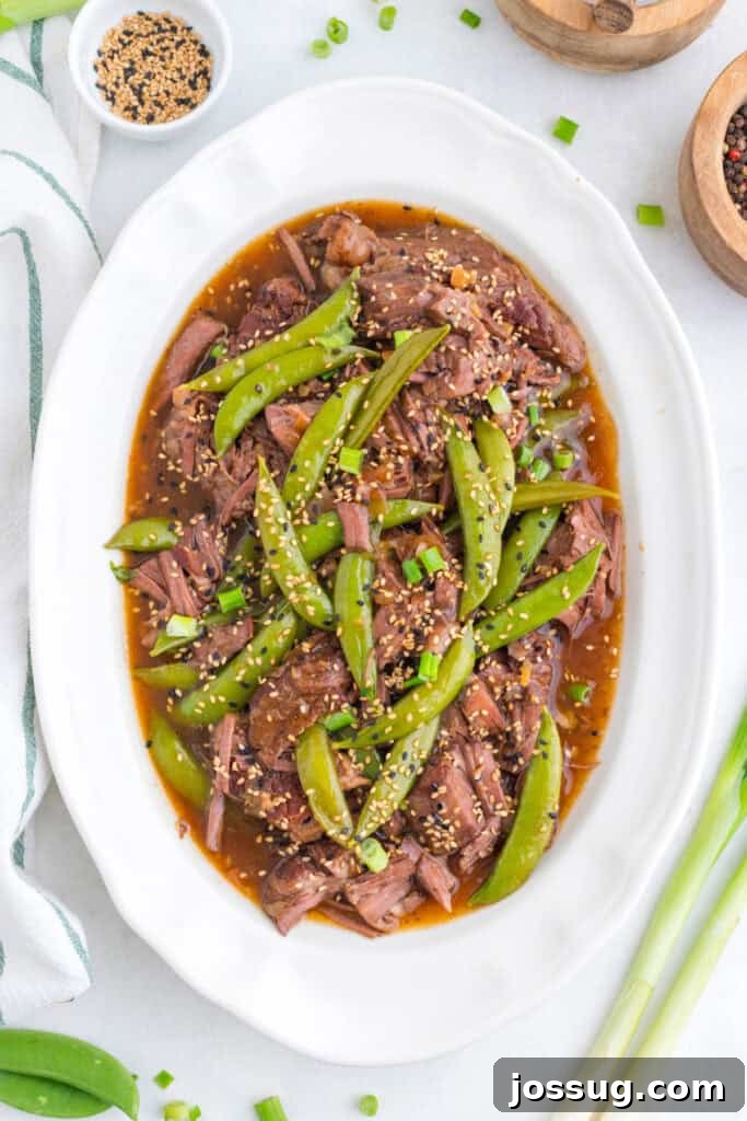 Slow Cooker Asian Pot Roast with Ginger Soy Glaze 10 Slow Cooker Asian Pot Roast with shredded beef, snap peas, green onions, sesame seeds, and soy-ginger sauce