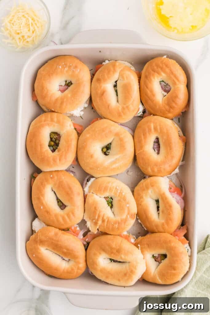 Baked Bagel and Smoked Salmon Sliders 11 Mini bagel tops placed over smoked salmon, cream cheese, red onion, capers, and dill