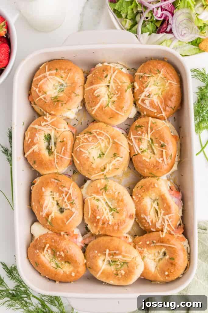 Baked Bagel and Smoked Salmon Sliders 17 Freshly baked Bagels & Lox Sliders topped with Parmesan and fresh dill in a baking dish