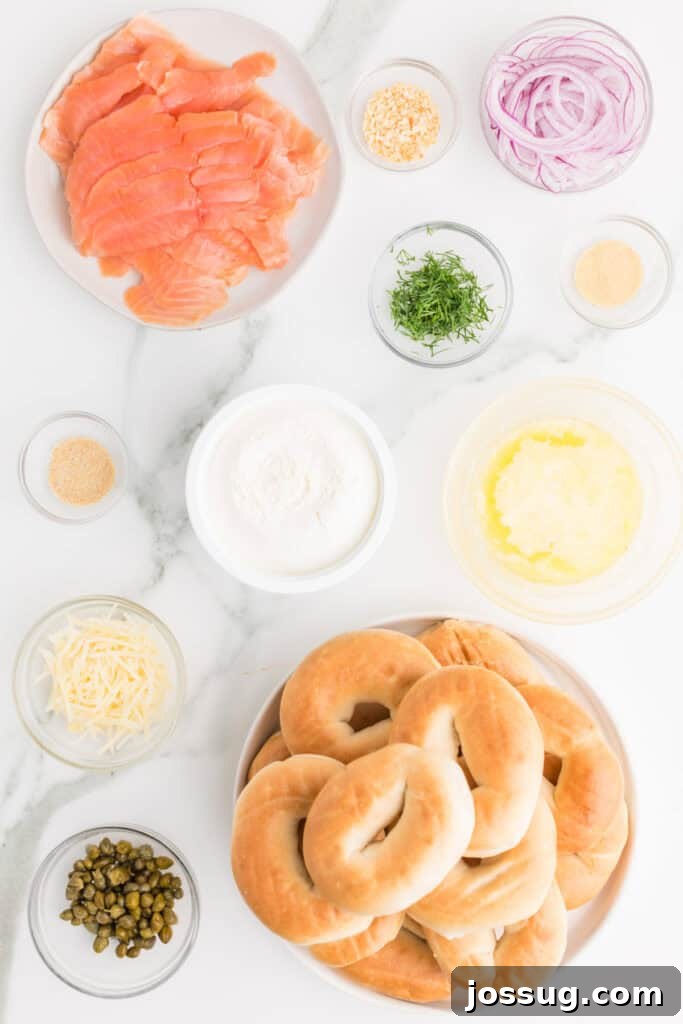 Baked Bagel and Smoked Salmon Sliders 3 Ingredients for Baked Bagels & Lox Sliders including mini bagels, smoked salmon, cream cheese, red onion, capers, dill, butter, and Parmesan