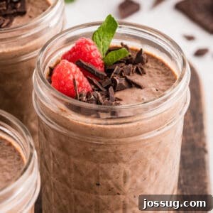 Creamy Chocolate Chia Pudding Recipe 12 Chocolate Chia Pudding topped with fresh raspberries, chopped dark chocolate, and mint in a glass jar