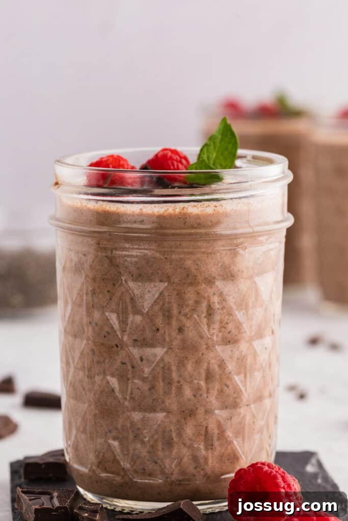 Creamy Chocolate Chia Pudding Recipe 10 Chocolate Chia Pudding in a glass jar topped with fresh raspberries, mint, and dark chocolate