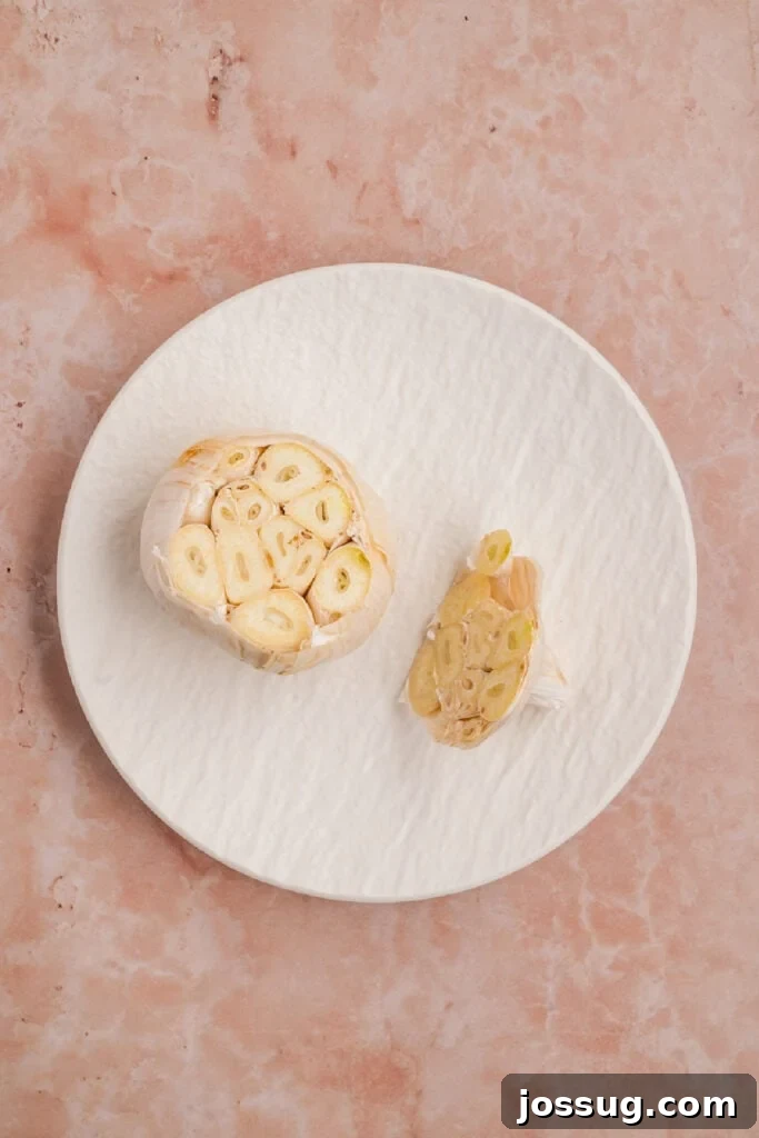 Whole garlic bulb with the top sliced off to expose the individual cloves