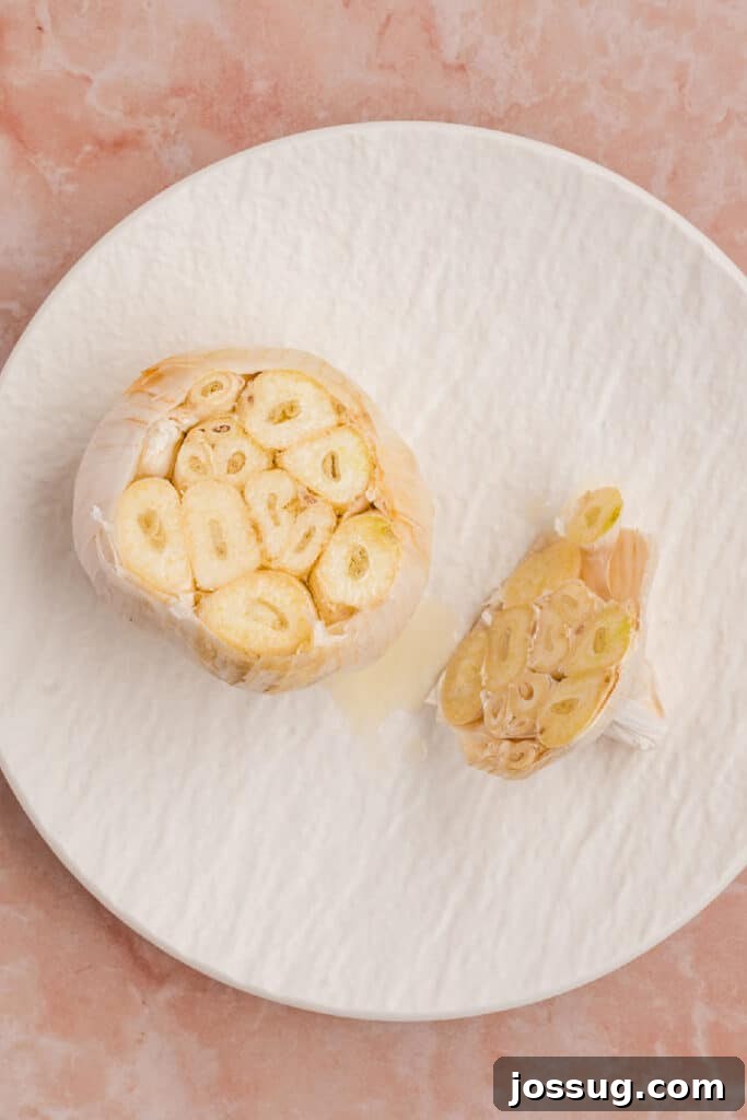 Cut garlic bulb drizzled with olive oil and sprinkled with salt before roasting